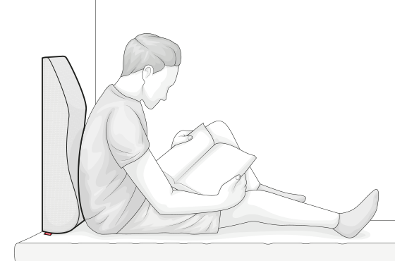 Illustration: une personne est assis et lit un livre, adossé à un repose jambes Bodyguard, placé à la vertical.